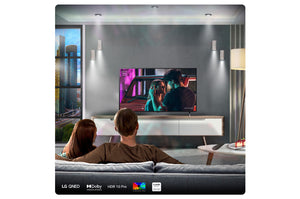 Two people sitting on a couch watching a TV in a modern living room.
